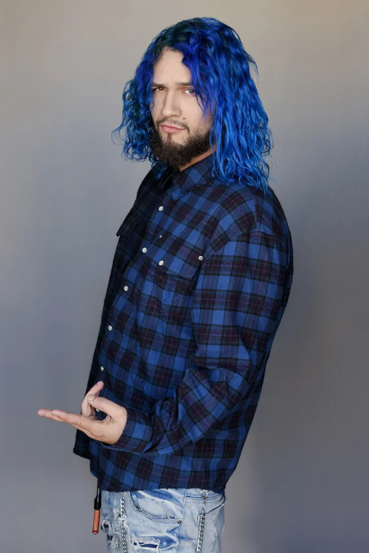 Fly South in a blue plaid shirt, three-quarter pose in the studio